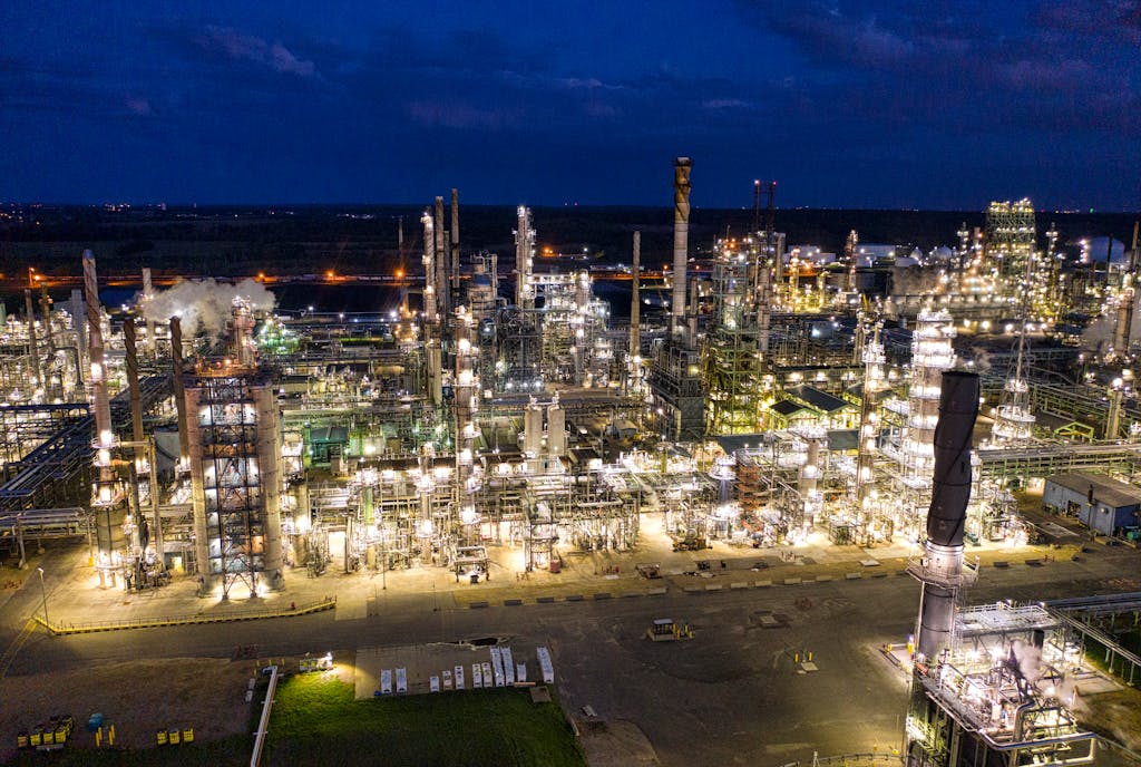 Aerial view of a brightly lit industrial refinery at night in Rosemount, MN.